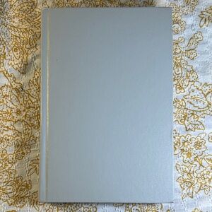 White Hardcover Book with Red Text